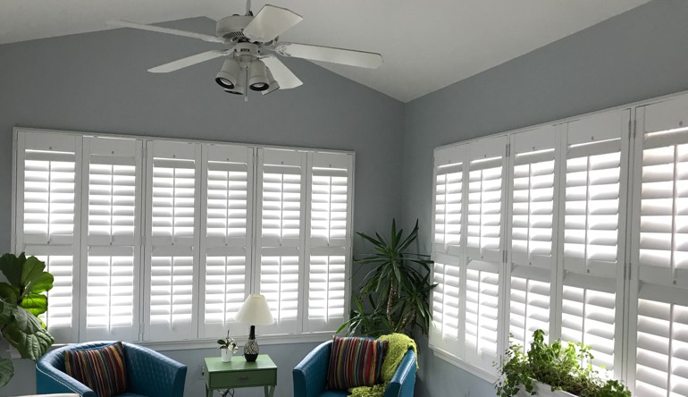 Bluff City sunroom with fan and shutters